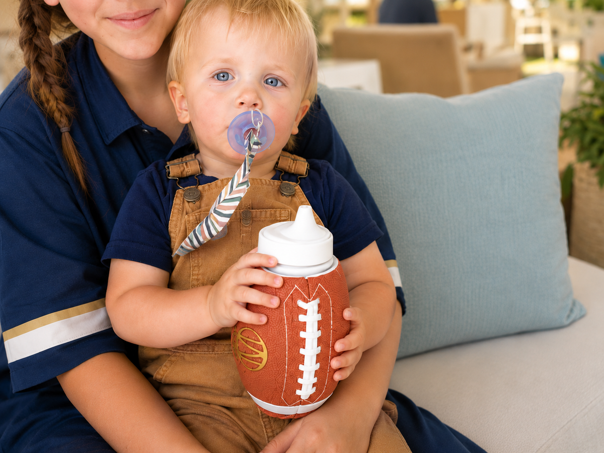 Two children sharing a family moment with a football-shaped Pro-Hands Sports Bottle.